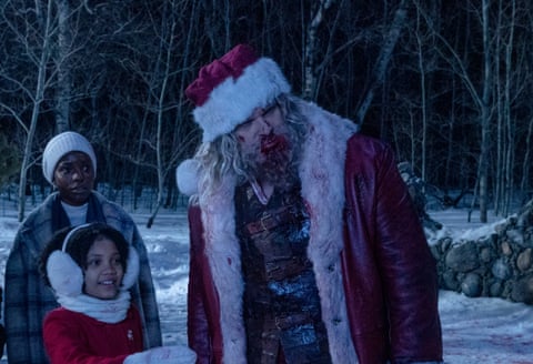 Alexis Louder, Leah Brady and David Harbour as Santa in Violent Night