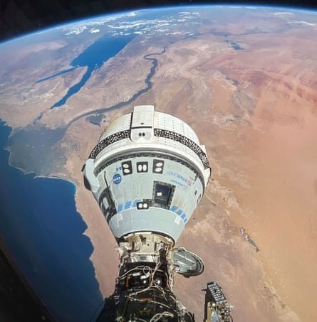 A teardrop-shaped pod attached to something out of view, in space with the curvature of Earth below it, looking down on northern Africa.