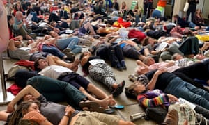 Extinction Rebellion protesters lie down during a staged ‘die-in’ at the Queensland Museum in Brisbane