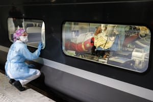 Paris, France: a member of the medical team watches from the platform as a patient infected with the Covid-19 virus is put on a train at Gare d’Austerlitz, ready to be transferred to a hospital in Brittany