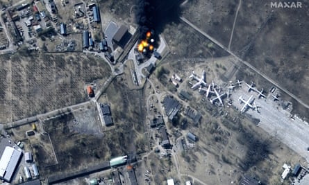 A satellite image shows buildings and fuel storage tanks on fire at the Antonov aircraft plant.