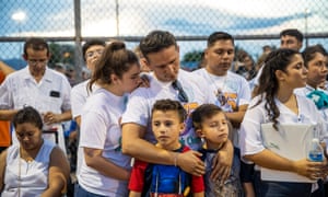 People take part in a prayer and vigil at Ponder Park in El Paso, Texas.