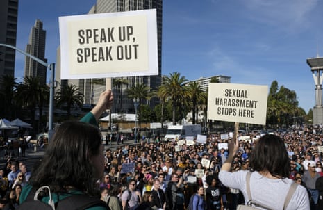 Google employees hold up signs during a walkout rally in San Francisco. 