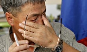 Shaariibuu Setev wipes away tears during a press conference in Kuala Lumpur in 2006