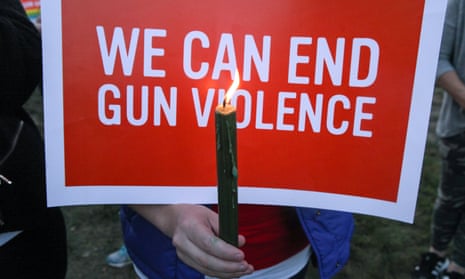 Mourners in Newtown, Connecticut, hold signs during a solidarity vigil in memory of victims of the Las Vegas shooting.
