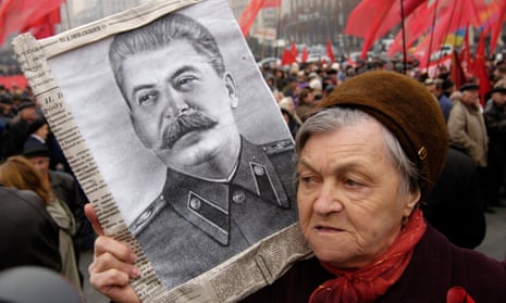 Supporter of the Ukrainian Communist Party holds a portrait of Joseph Stalin during a rally in 2005