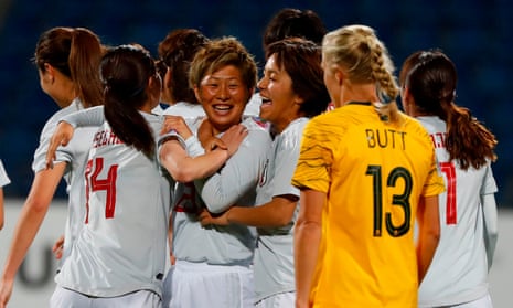 Kumi Yokoyama celebrates after her late goal for Japan while Tameka Butt looks dejected for Australia.