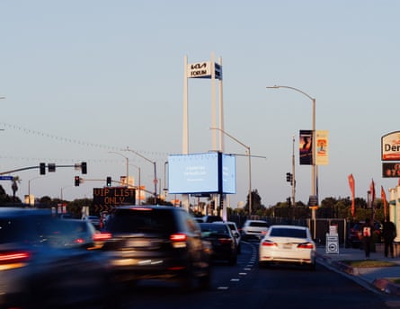 Traffic is seen from the street with a sign to the left advertising parking for “VIP List Only” and another sign in the middle for the Kia Forum.