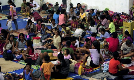 Evacuees from coastal villages shelter inside an evacuation centre