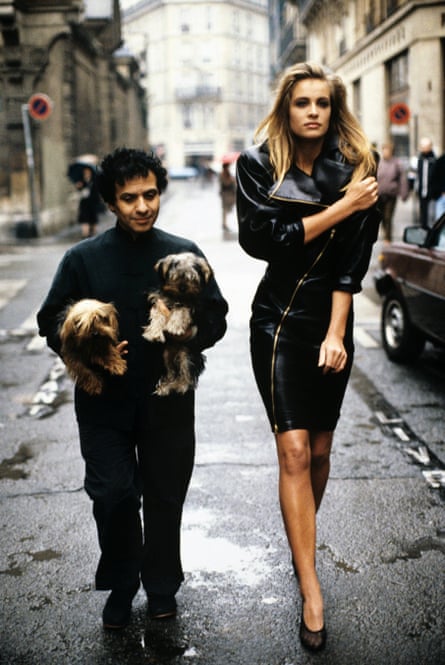 Alaïa with model Frederique van der Wal and his two Yorkshire terriers Patapouf and Wabo in Paris in 1986. Van der Wal is wearing one of his creations, a black leather zippered dress.