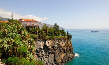 Reid’s Palace Hotel, near a cliff-edge, overlooking blue sea in Madeira