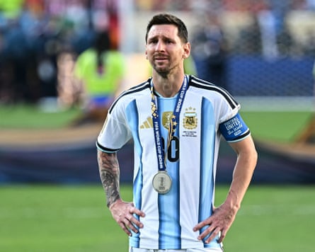 Man wearing football jersey and medal.