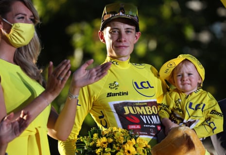 Jumbo-Visma’s Jonas Vingegaard holds his daughter Frida on the podium.