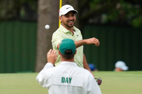 Jason Day tosses his ball to his caddie after a birdie on the 3rd.