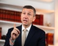 Ken Martin gestures with his finger raised while speaking in an office setting