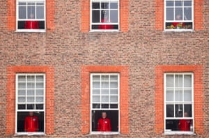 Chelsea Pensioners watch a Remembrance Sunday service from their windows at the Royal Hospital Chelsea