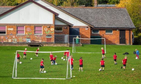 Football practice on a school sports field.