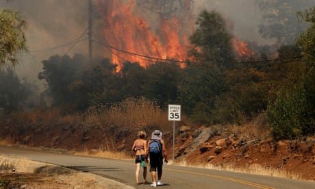 people walk near a fire