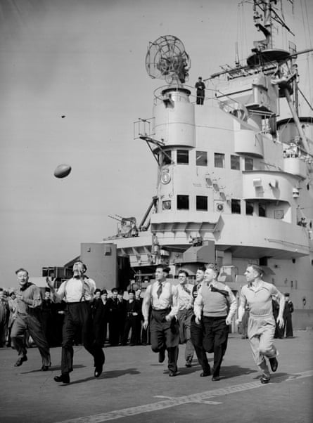 The ‘England’ team toss a ball around on HMS Indomitable as they travel to Australia in 1946.