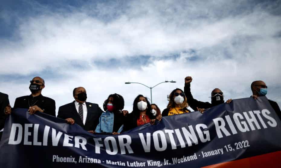 Martin Luther King III, Yolanda Renee King, Arndrea Waters King and other activists hold a banner during a demonstration for voting rights in Phoenix in January.