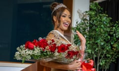 Woman wearing tiara with flowers waves to camera