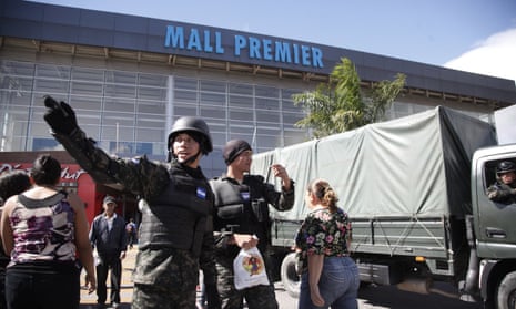 Soldiers stand guard outside a shopping mall in Tegucigalpa, Honduras, on Saturday.
