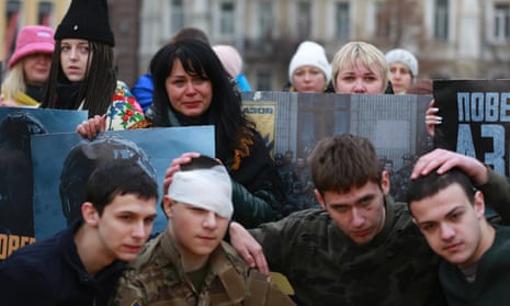 Ukrainians gather for a demonstration in Sofia Square to demand the release of the soldiers captured in the ongoing war against Russia, as they hold banners, in Kyiv, Ukraine.