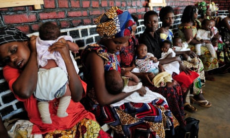 Mothers soothe their babies after vaccinations in Bugasera district, Rwanda