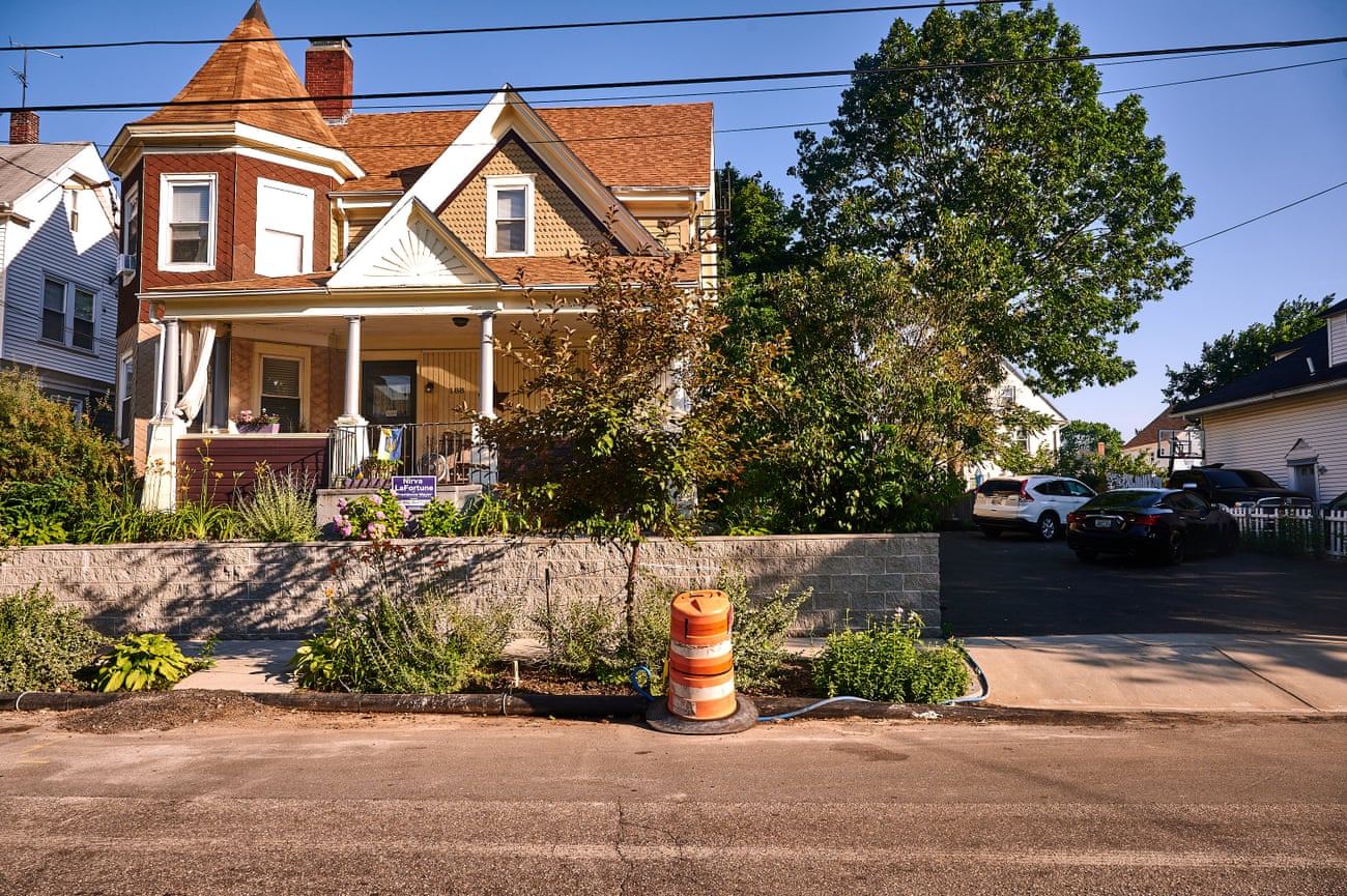 House with water pipe and construction barrier in the foreground