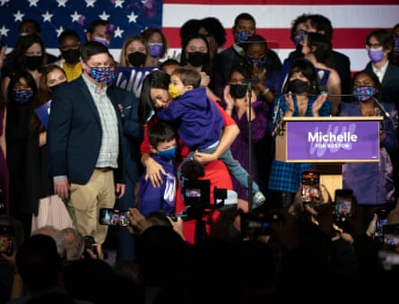 Michelle Wu hugs her children Cass and Blaise after winning her race for mayor of Boston, to become the first woman and first person of color to be elected to the office.