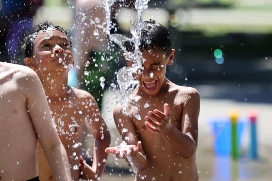 Boys play in a splash park at the Georgetown Playfield in Seattle on 26 June.