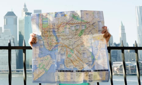 A visitor holds a New York City map in Brooklyn.