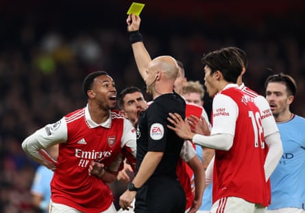 Gabriel of Arsenal looks aghast as referee Anthony Taylor awards him a yellow card against Manchester City, before the decision is reversed following a VAR review