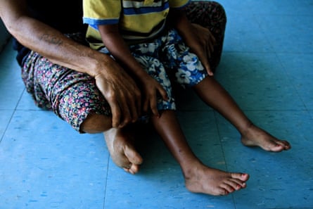 Paula and her son sit in a sexual violence refuge in the Papua New Guinean city of Lae