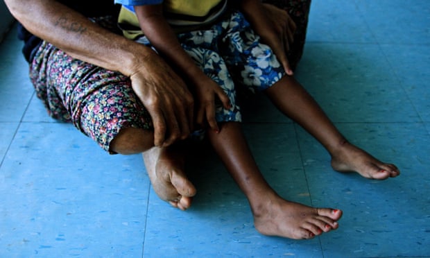 A child sitting on an adult’s lap