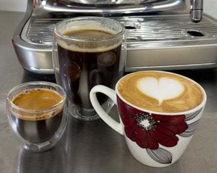 Three cups of coffee – an espresso, flat white and americano – in front of the Oracle Jet
