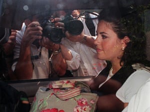 Monica Lewinsky in ca car surrounded by photographers