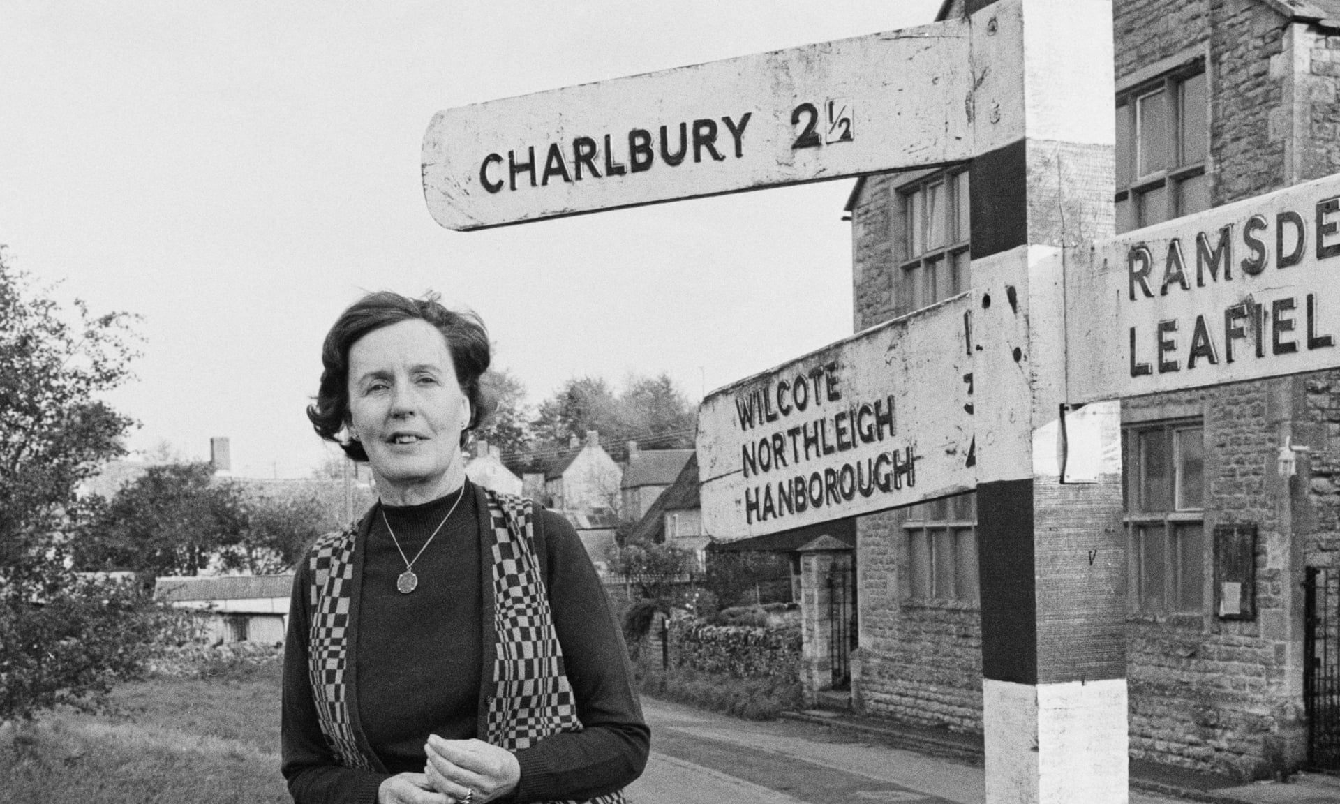 Barbara Pym, standing beside a direction signpost in the village of Finstock, Oxfordshire in 1979. Photograph: United News/Popperfoto/Getty Images
