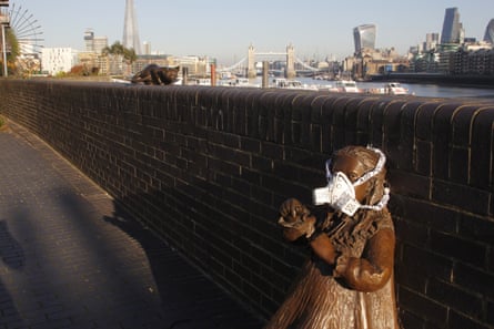 Greenpeace activists fit the statue of Doctor Salter’s Daughter with an emergency face mask to demand action on air pollution.
