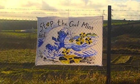 A hand-drawn banner on a fence near the proposed coal mine in Cumbria reads ‘Stop the Coal Mine’