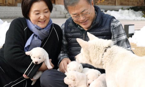 Moon Jae-in and his wife, Kim Jung-sook, pictured in 2018 holding puppies born from one of the dogs received from North Korea