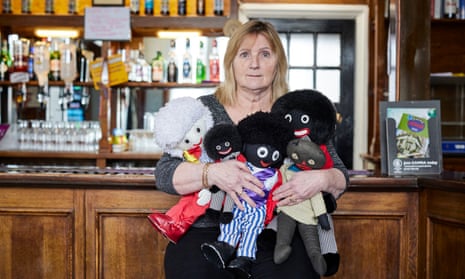 Benice Riley at the bar of the The White Hart Inn with her golliwog dolls