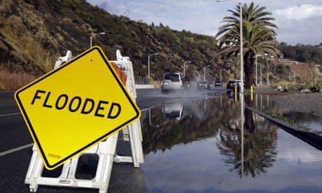 A sign warning of flooded road is posted in Malibu, California, after heavy rain during storms spawned by El Niño in 2016.