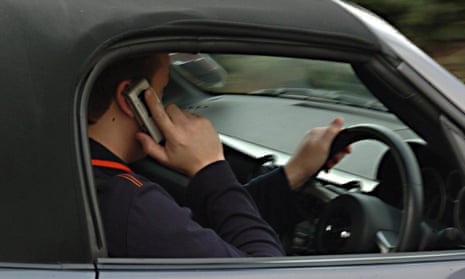 A man using a phone while driving