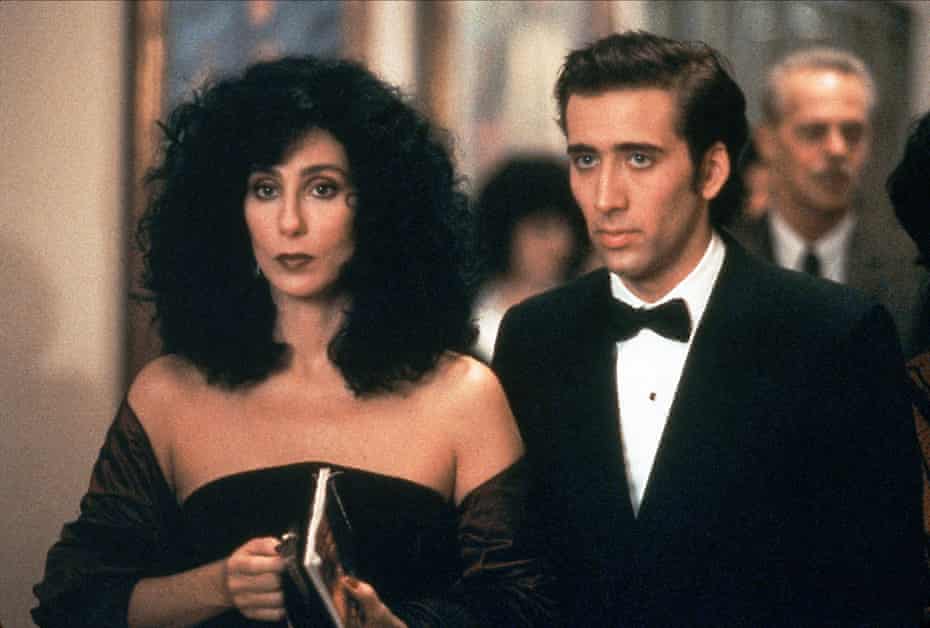 Cher and Nicolas Cage in formal dinner dress, looking pensive