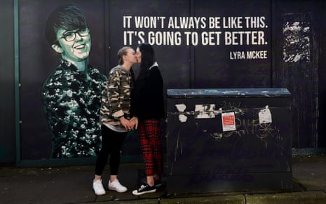 Robyn Peoples (left) and Sharni Edwards, Northern Ireland’s first same-sex couple to be legally married, in front of the Lyra McKee mural in Belfast, in February 2020