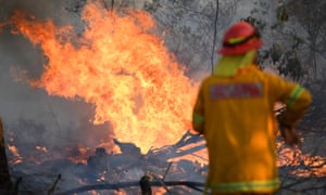 A firefighter works to contain a bushfire near Glen Innes, New South Wales, Australia. Three people have been killed and 150 homes destroyed in the latest fires.