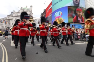 Members of the Queen’s Guard entertain along the route