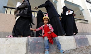 A displaced Yemeni child waits for her mother registering at an evacuation center after fleeing home in the war-affected port city of Hodeidah. 5760.jpg?width=300&quality=85&auto=forma