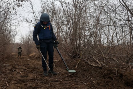 Ukrainian bomb disposal experts search for unexploded ordnance near energy infrastructure facilities in Kharkiv.
